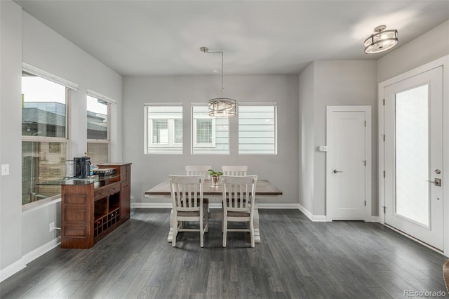 dining room with dark wood finished floors and baseboards