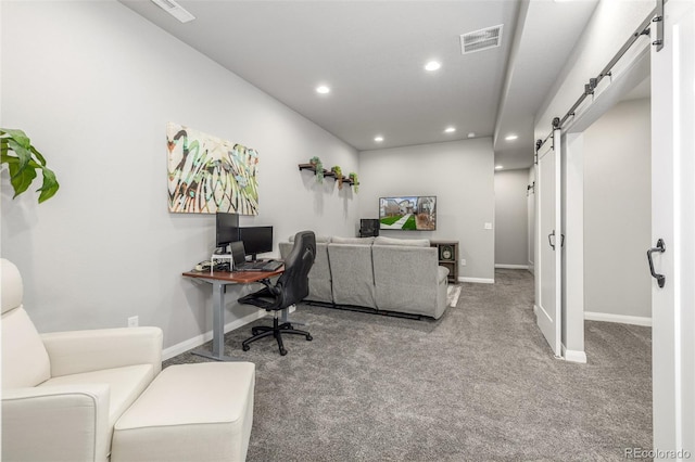 carpeted office space with recessed lighting, visible vents, baseboards, and a barn door