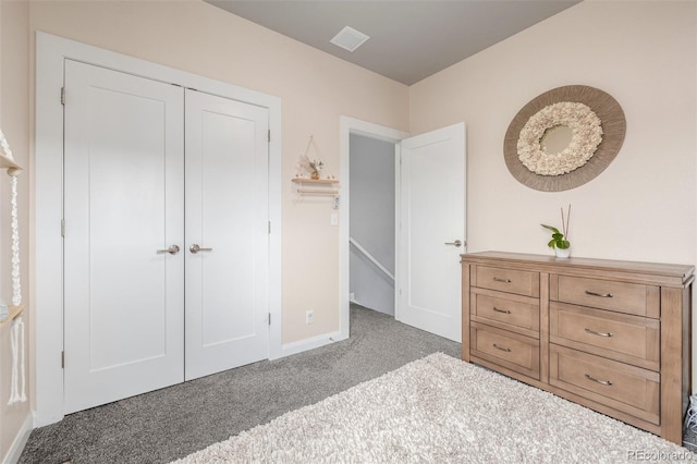 unfurnished bedroom with a closet, carpet flooring, and baseboards