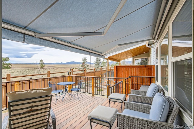 wooden deck with fence and a mountain view