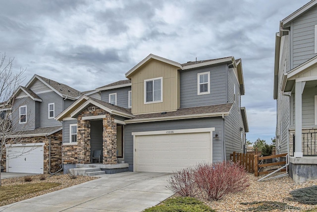 craftsman house featuring stone siding, a garage, fence, board and batten siding, and driveway