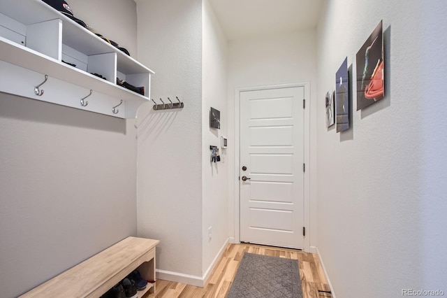 mudroom featuring baseboards and light wood-style floors