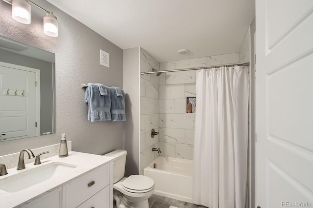 full bath with shower / tub combo, toilet, visible vents, vanity, and a textured wall