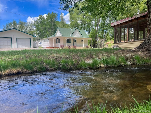 15071 County Road 306, Buena Vista, CO 81211 - view of front of house with a garage, covered porch, and a water view
