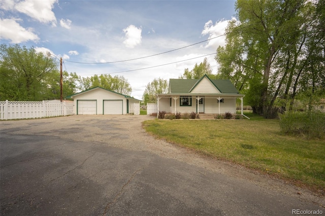 15071 County Road 306, Buena Vista, CO 81211 - farmhouse-style home featuring covered porch, a detached garage, and an outdoor structure