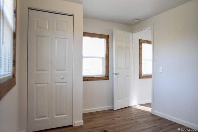 15071 County Road 306, Buena Vista, CO 81211 - unfurnished bedroom featuring baseboards, dark wood finished floors, and a closet