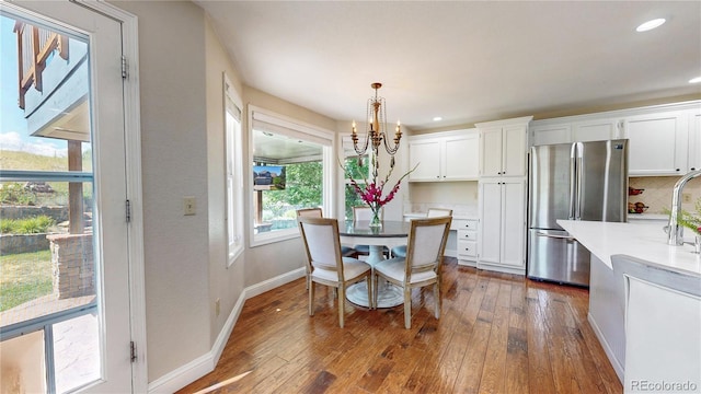 9992 Cottoncreek Dr, Highlands Ranch, CO 80130 - dining space with a chandelier, dark wood-style floors, and recessed lighting