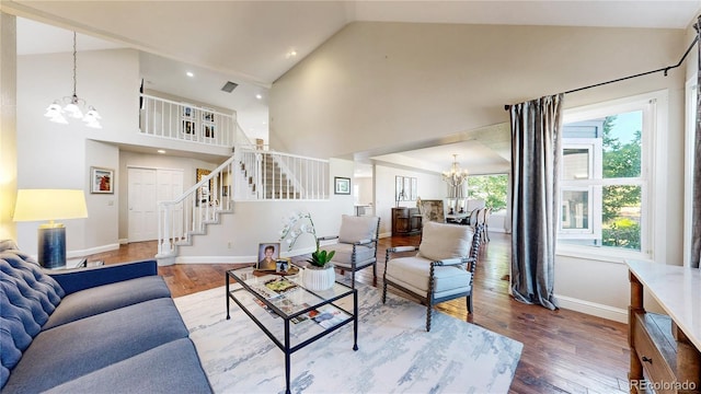 9992 Cottoncreek Dr, Highlands Ranch, CO 80130 - living area featuring a chandelier, wood finished floors, stairs, and high vaulted ceiling