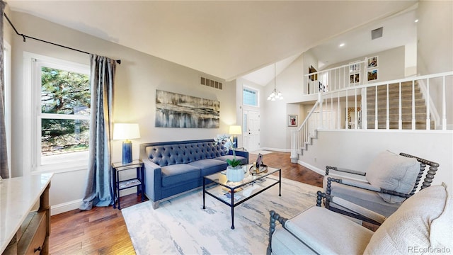 9992 Cottoncreek Dr, Highlands Ranch, CO 80130 - living room featuring stairs, healthy amount of natural light, wood finished floors, high vaulted ceiling, and recessed lighting