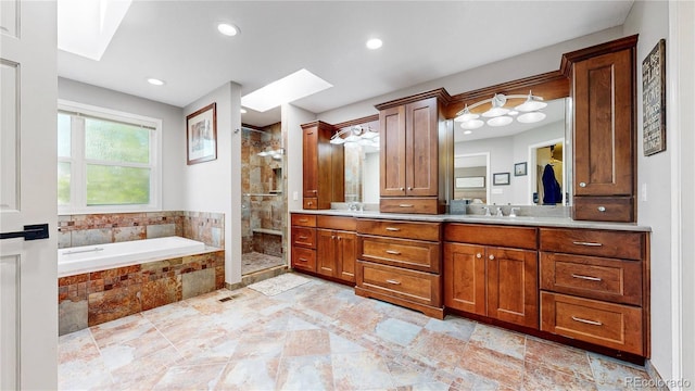9992 Cottoncreek Dr, Highlands Ranch, CO 80130 - bathroom featuring double vanity, a shower stall, a garden tub, a skylight, and recessed lighting