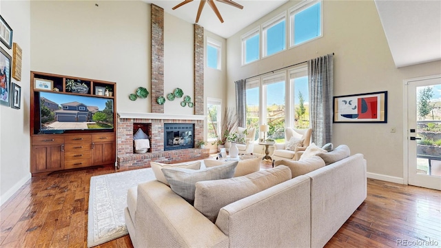9992 Cottoncreek Dr, Highlands Ranch, CO 80130 - living area with a towering ceiling, hardwood / wood-style floors, a fireplace, and a ceiling fan