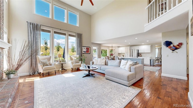9992 Cottoncreek Dr, Highlands Ranch, CO 80130 - living room with hardwood / wood-style floors, a towering ceiling, plenty of natural light, a ceiling fan, and recessed lighting