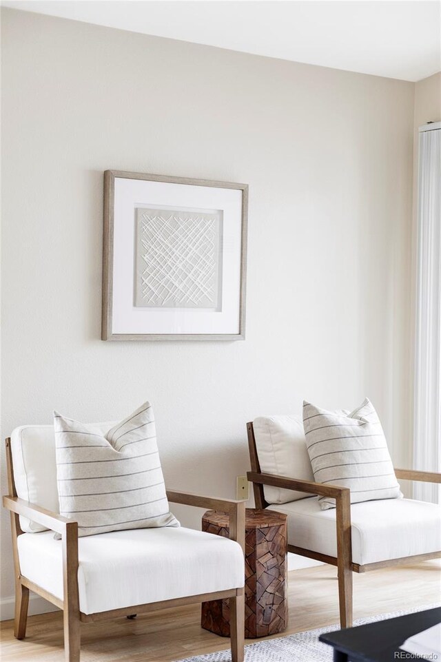 sitting room featuring light wood-style floors and baseboards