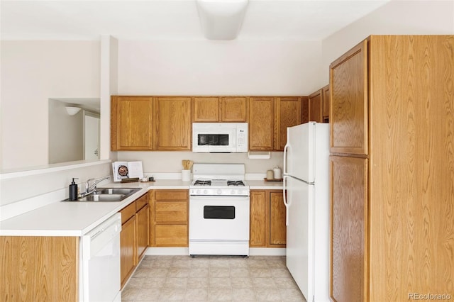 kitchen featuring white appliances, brown cabinetry, light countertops, light floors, and a sink