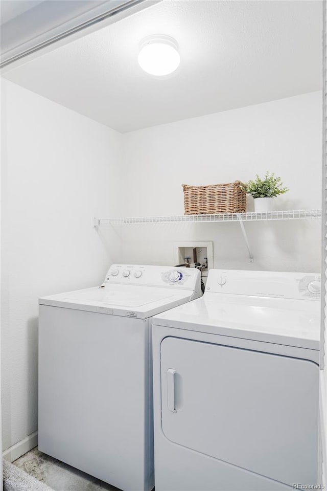 clothes washing area featuring washer and dryer and laundry area