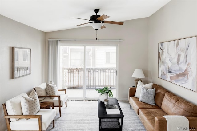 living area featuring lofted ceiling and a ceiling fan