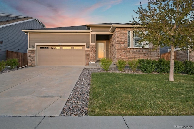 view of front of property with stone siding, an attached garage, and driveway