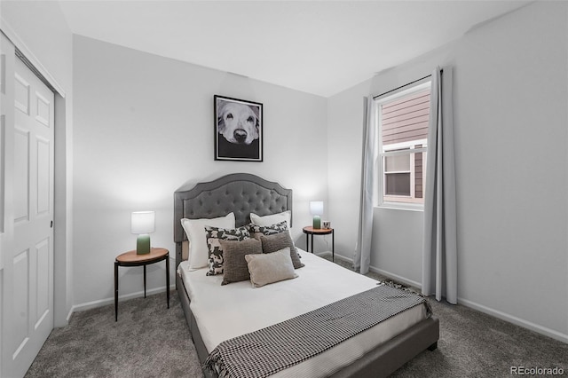 carpeted bedroom with baseboards and a closet