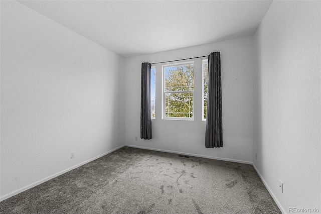 carpeted spare room with baseboards