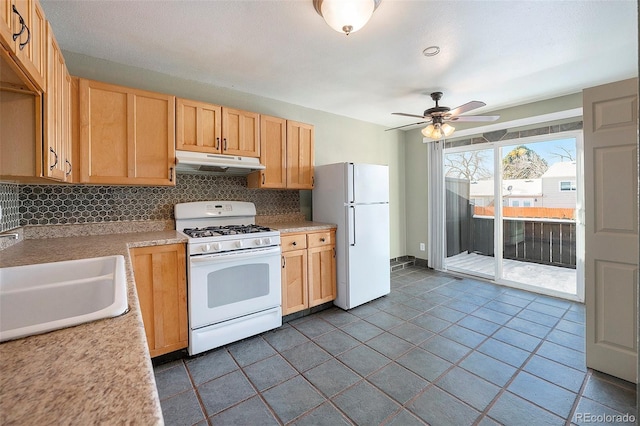 kitchen with sink, white appliances, ceiling fan, light brown cabinets, and decorative backsplash