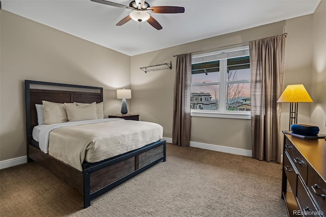 bedroom with baseboards, a ceiling fan, and light colored carpet