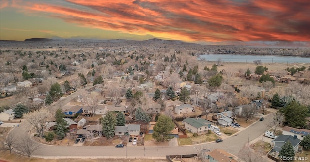 birds eye view of property with a water and mountain view