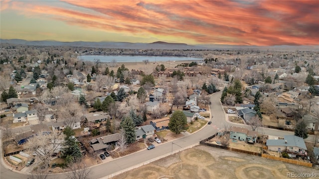 birds eye view of property with a residential view and a water and mountain view