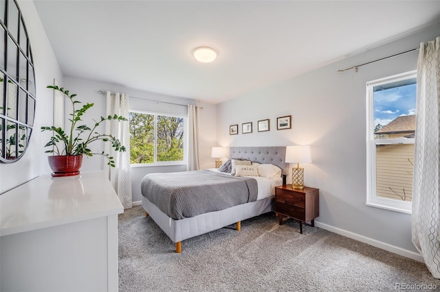 carpeted bedroom featuring baseboards