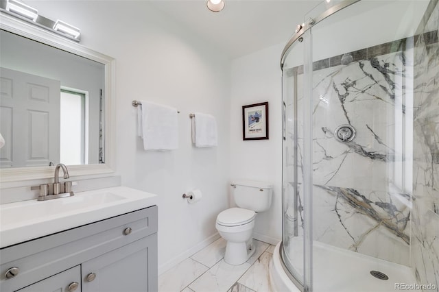 bathroom featuring vanity, marble finish floor, toilet, baseboards, and a marble finish shower