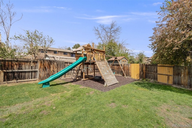 view of jungle gym featuring a lawn and a fenced backyard