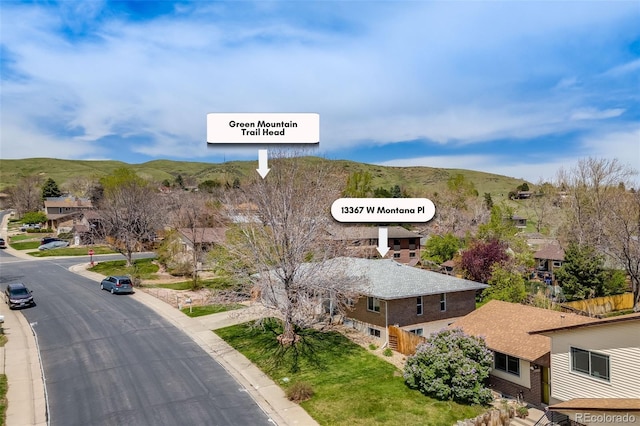 exterior space featuring a residential view, a mountain view, and curbs