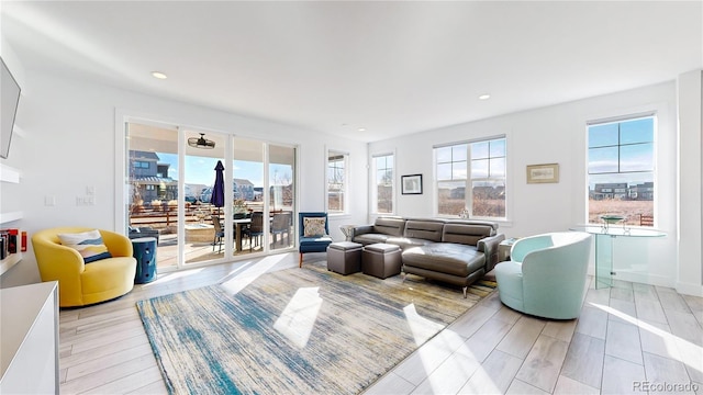 885 Delechant Dr, Erie, CO 80516 - living area with baseboards, recessed lighting, light wood-type flooring, and a city view