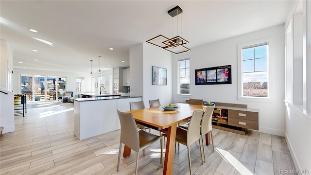 885 Delechant Dr, Erie, CO 80516 - dining area with wood tiled floor, a wealth of natural light, and recessed lighting