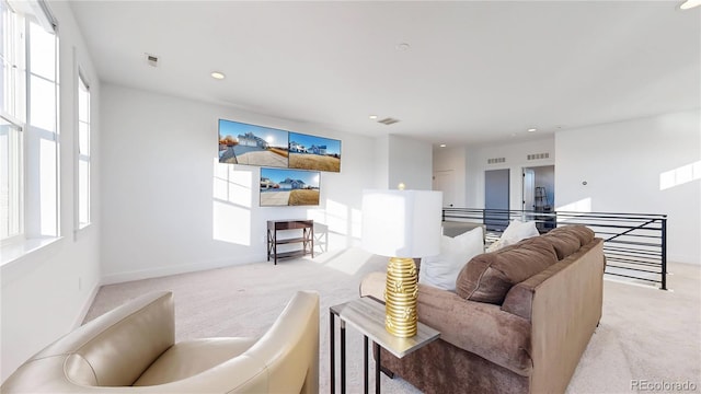 885 Delechant Dr, Erie, CO 80516 - living room featuring visible vents, a wealth of natural light, and light colored carpet