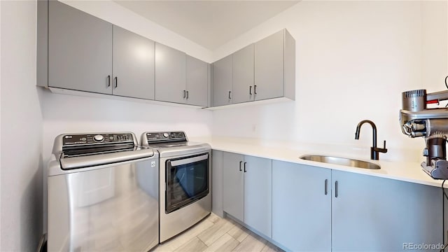 885 Delechant Dr, Erie, CO 80516 - laundry room with washer and dryer, cabinet space, a sink, and wood tiled floor