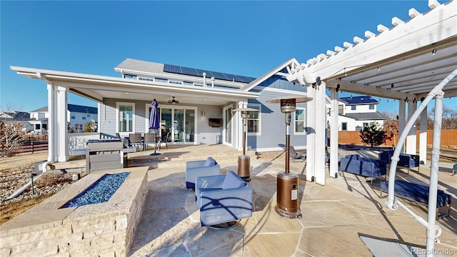885 Delechant Dr, Erie, CO 80516 - view of patio / terrace featuring a fire pit, outdoor dining area, fence, and a pergola