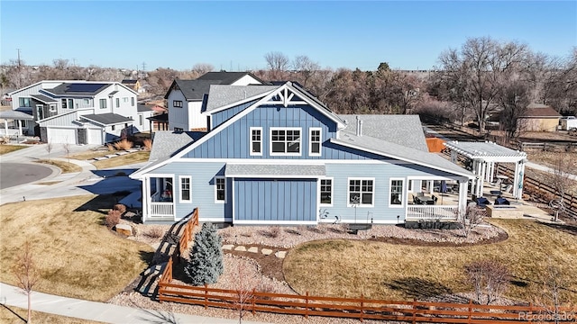 885 Delechant Dr, Erie, CO 80516 - rear view of property featuring a shingled roof, fence, a lawn, a residential view, and board and batten siding