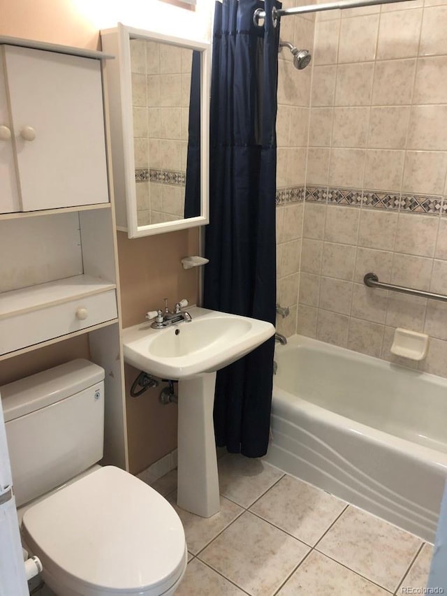 bathroom featuring tile patterned flooring, toilet, and shower / bath combo with shower curtain