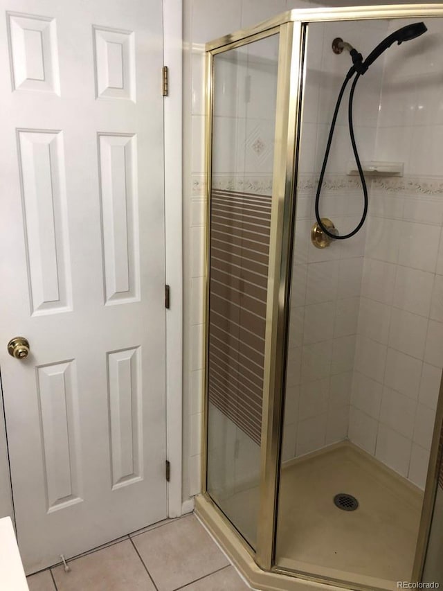 bathroom featuring a stall shower and tile patterned flooring