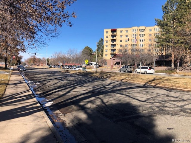 view of road featuring curbs and traffic signs