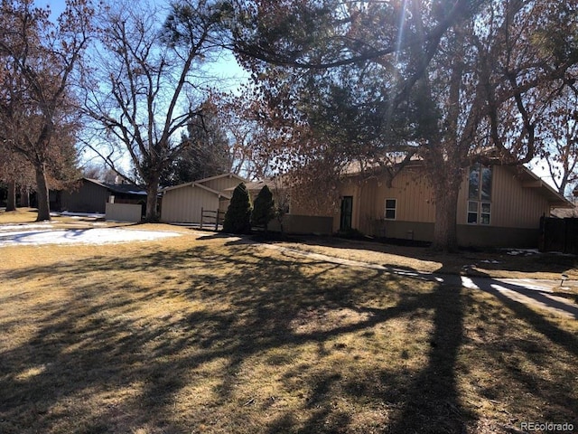 view of side of property with a lawn