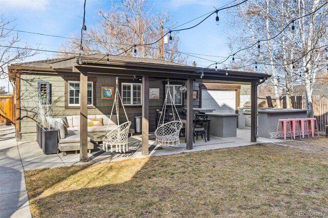 rear view of property featuring a lawn, outdoor dry bar, fence, a patio area, and an outdoor living space