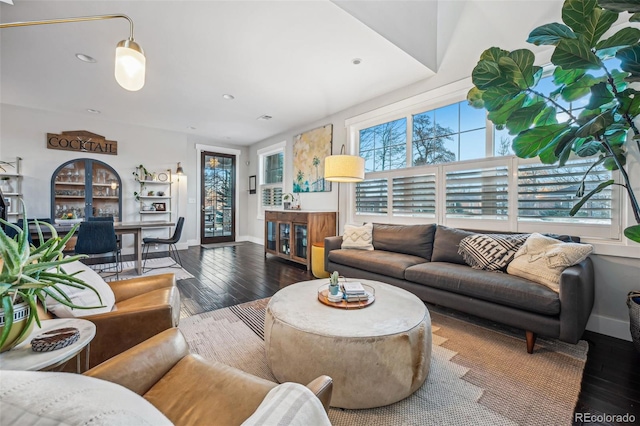 living room featuring hardwood / wood-style flooring, baseboards, and recessed lighting