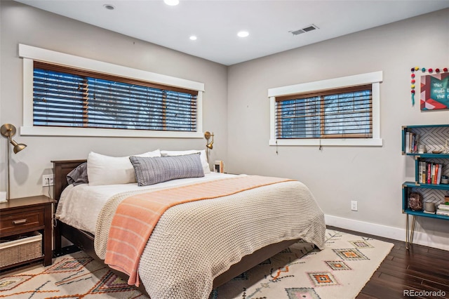 bedroom featuring recessed lighting, visible vents, baseboards, and wood finished floors