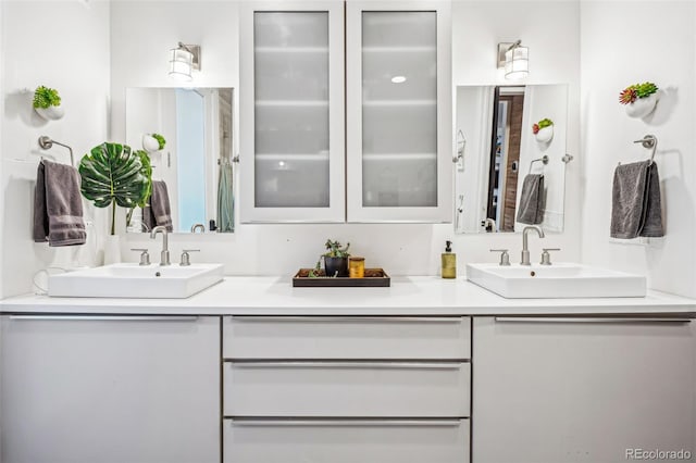 full bathroom featuring double vanity and a sink