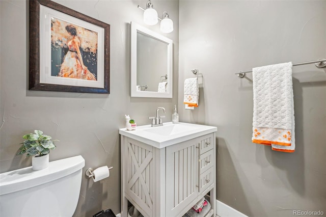 half bath with vanity and toilet