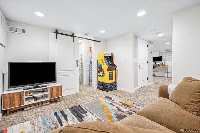 carpeted living area featuring baseboards, a barn door, visible vents, and recessed lighting