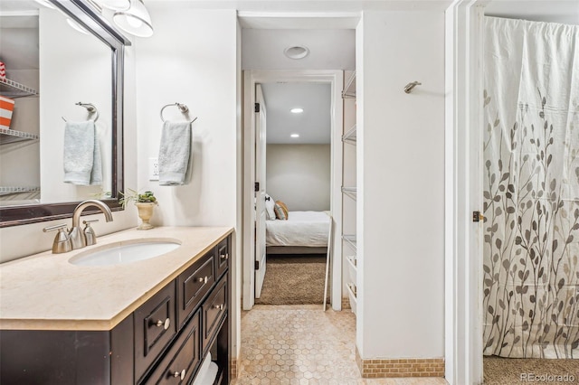 bathroom featuring a shower, connected bathroom, and vanity