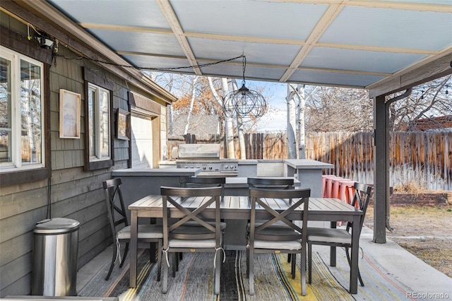 view of patio with area for grilling and fence