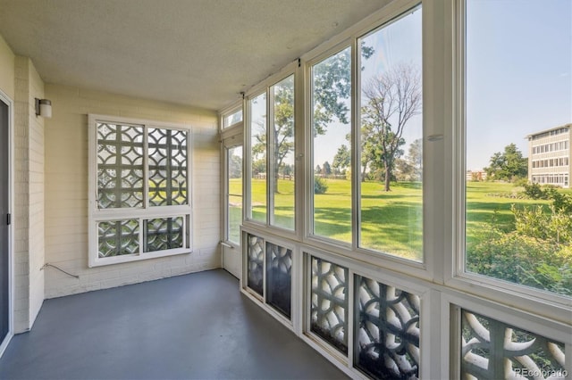 9380 E Center Ave Unit 8A, Denver, CO 80247 - unfurnished sunroom featuring concrete floors and a textured ceiling